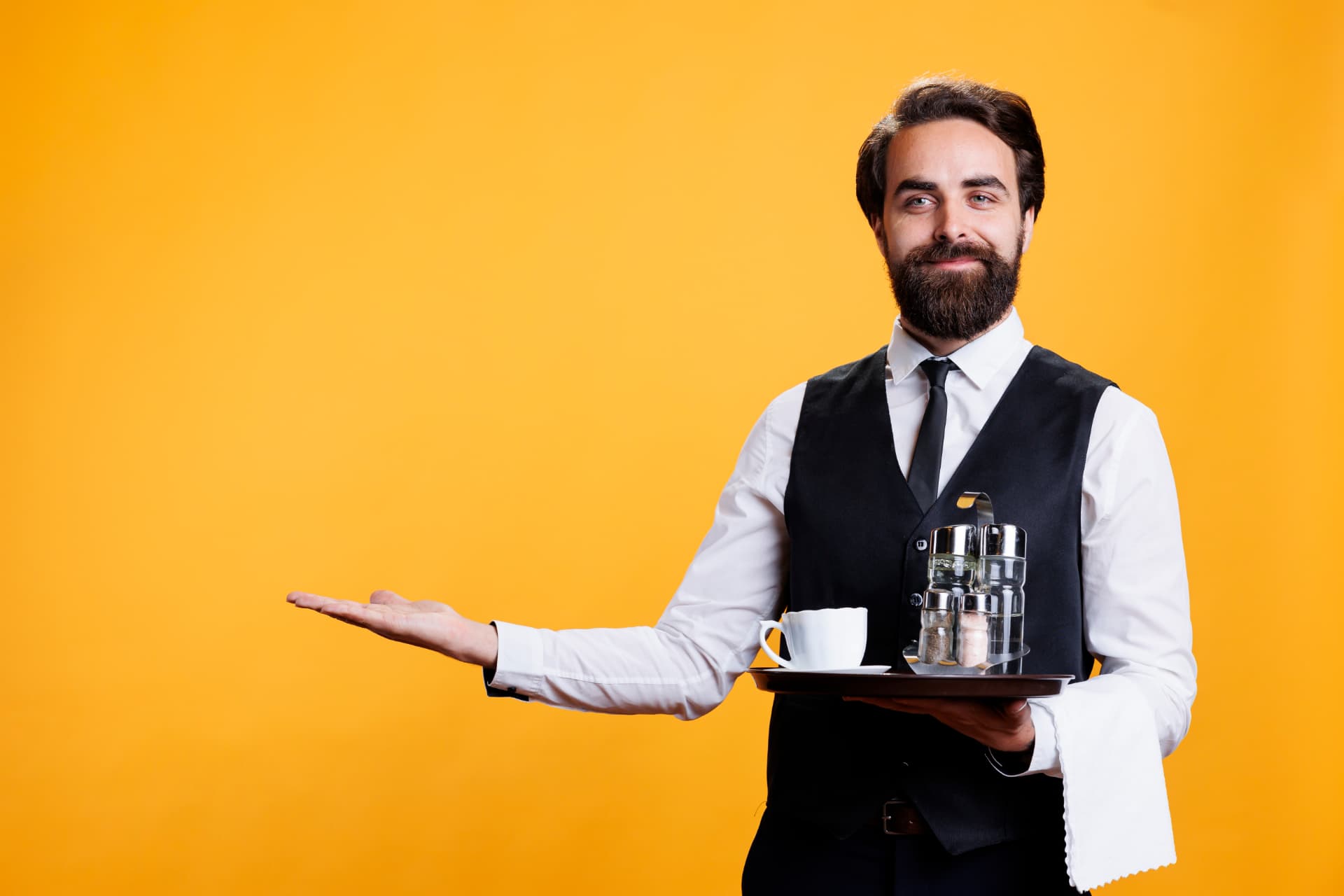 Hotel service associate presenting a tray of coffee service